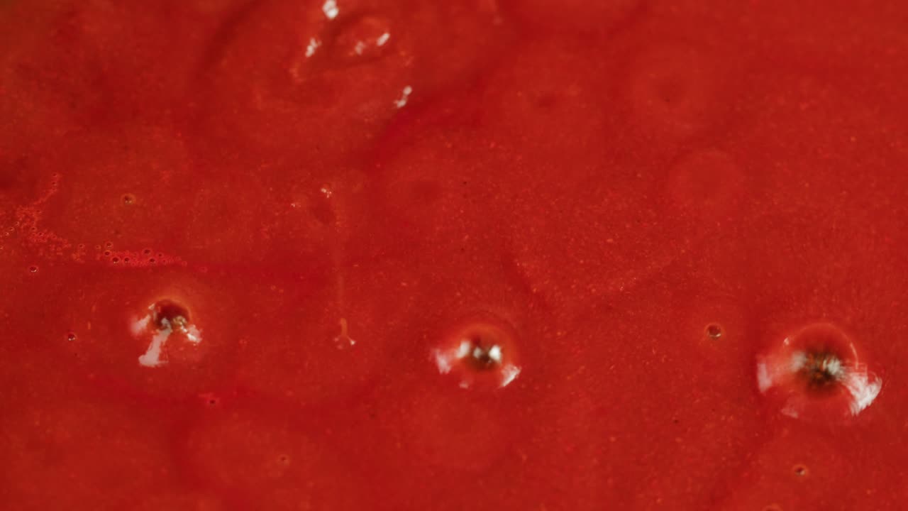 Boiling tomato sauce on a frying pan close-up. Cooking tomato sauce or soup. Traditional Italian Mexican Asian dish. High quality studio shot for cafe, restaurant close up. Marinara sauce for Italian pasta