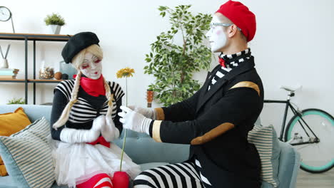mime couple sharing a flower