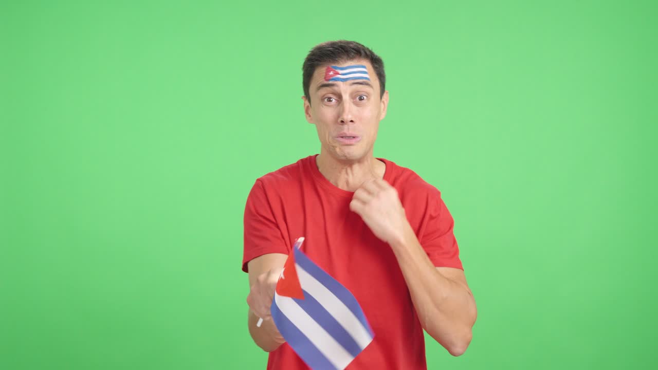 Man cheering for Cuba during a match that is lost