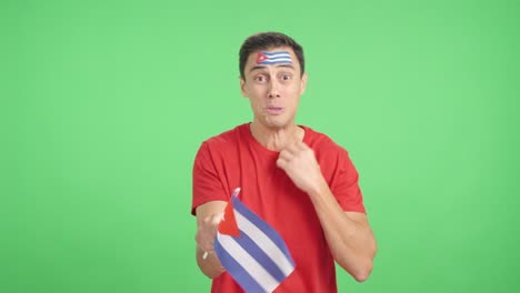 man cheering for cuba during a match that is lost