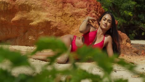 a caribbean beach is adorned by an indian girl in a stylish red bikini, enjoying the tropical vibes