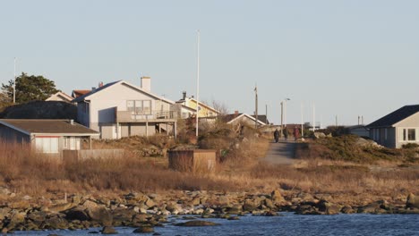 Static-shot-of-West-coast-in-Sweden-with-modern-summer-houses-on-a-warm-summer-evening