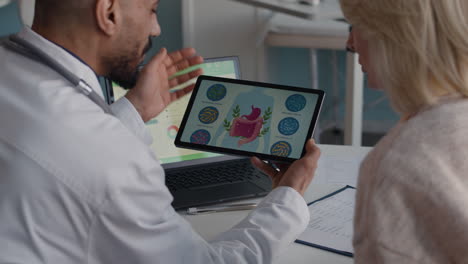 doctor explaining gut health to patient using a tablet
