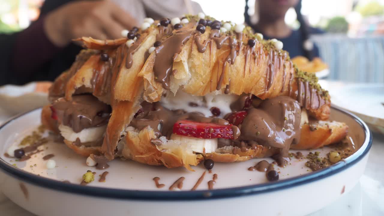 Croissant dessert with chocolate, strawberry, banana, and ice cream