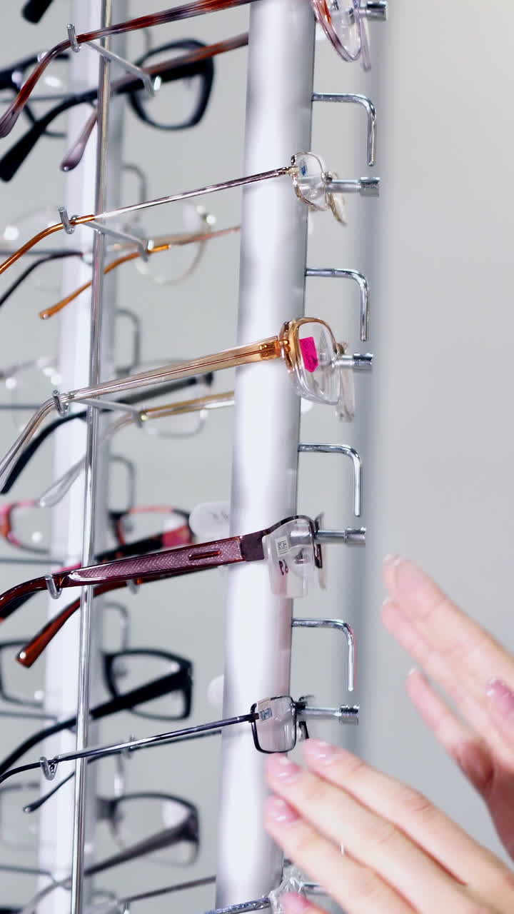 Woman Choosing Eyeglasses. Close up of female trying glasses at shop store