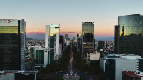 aerial ascending shot of the reforma avenue, vibrant dusk sky in mexico city