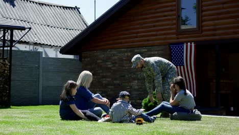 military man with family in backyard