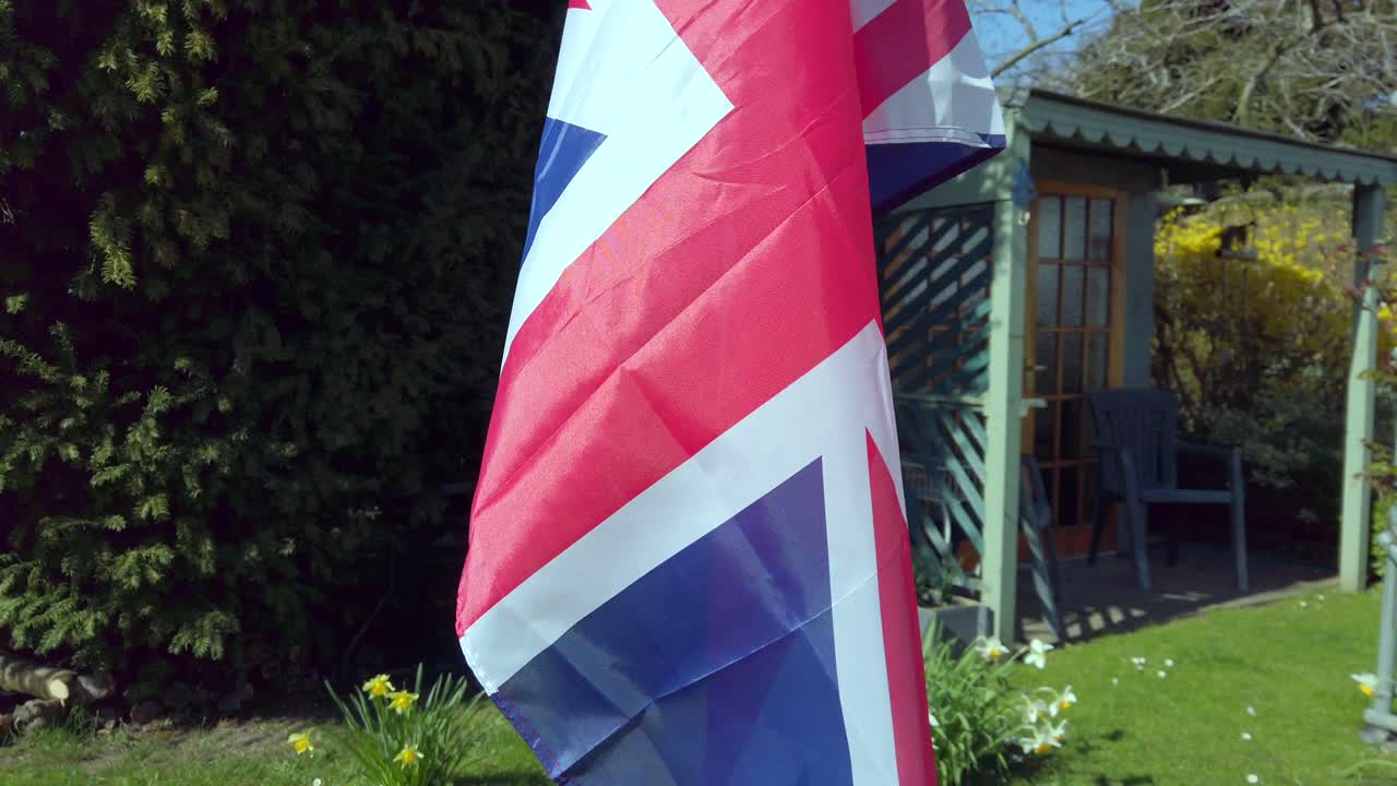 Union Jack flag in English garden Spring time - Slow Mo 4k 24FPS