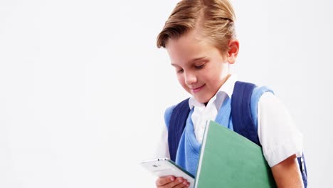 Schoolboy-using-mobile-phone-against-white-background