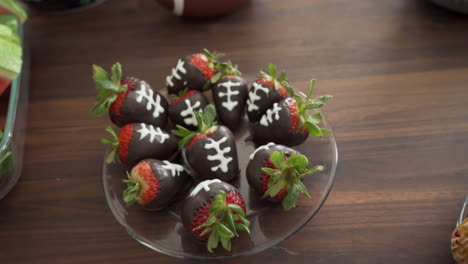 Party-Smorgasbord-of-Snacks-on-Table-with-Chocolate-Covered-Strawberries-as-Footballs