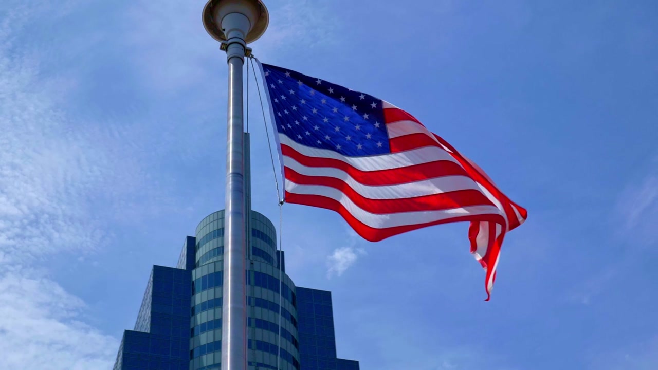 Slow Motion of the American Stars and Strips flag waving in New Jersey against a blue sky