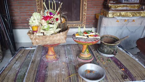 Balinese-Hindu-Flower-Priest-Offerings-Displayed-on-the-Temple,-Sage-Holy-Water-and-Coconut-Leaves-Ornaments,-Religion