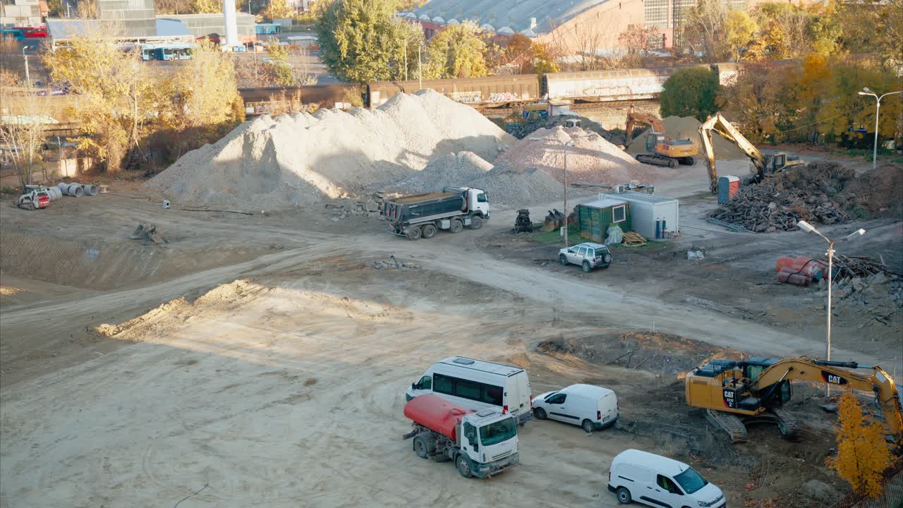 Aerial View of a Construction Site with Heavy Machinery and Trucks