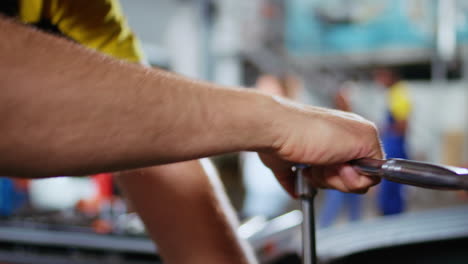 worker replaces car engine in garage