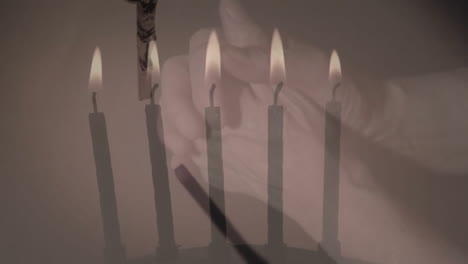 animation of rosary and burning candles over hands parying