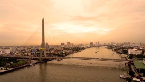 rama 8 bridge, suspension bridge crossing chao phraya river in bangkok city at sunset, thailand. 4k cityscape vdo