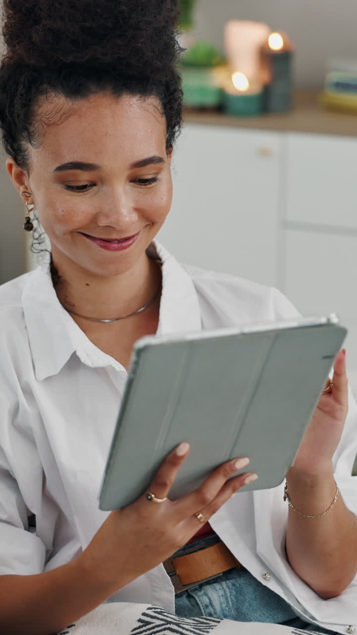 Young Woman Smiling While Using Digital Tablet