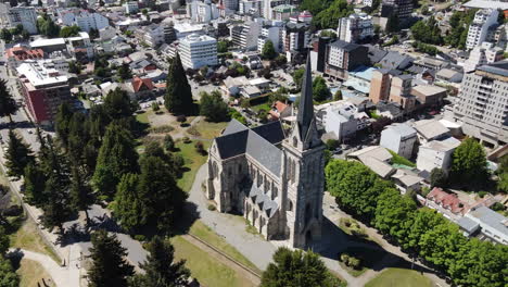 AERIAL---Cathedral-next-to-Nahuel-Huapi-lake,-Bariloche,-Rio-Negro,-Argentina,-spinning-shot