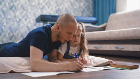 parent helps daughter with ponytails do homework at home
