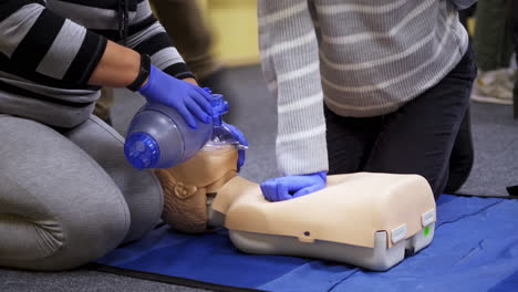 dummies for medics used for first aid training. experienced unrecognizible doctor gives recommendations. oxygen mask on medical doll.