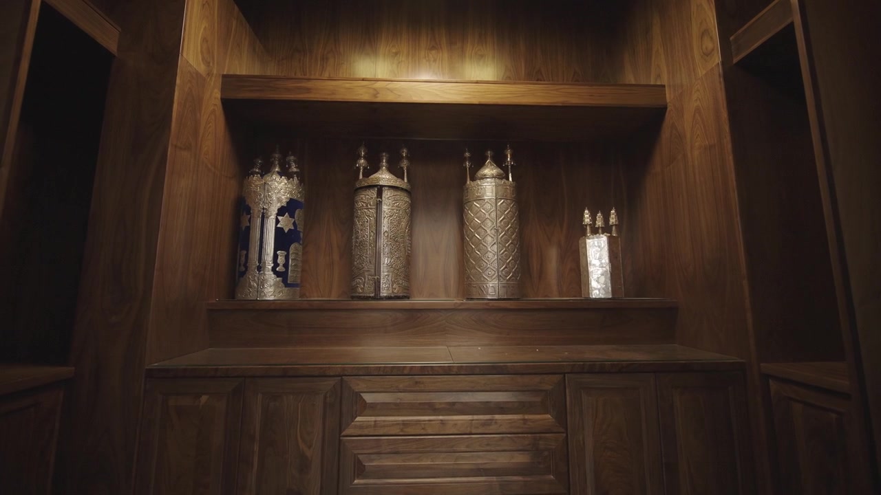 Sacred Torah Scrolls Displayed in Wooden Torah Ark with Elegant Carvings in Synagogue Interior