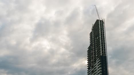 skyscraper under construction with cloud sky.