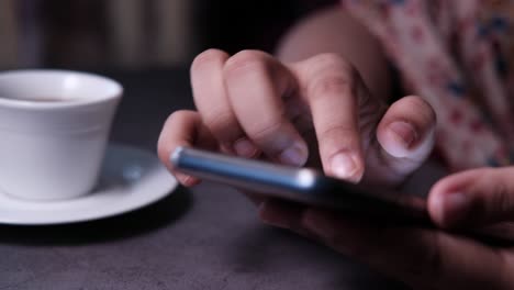 woman using smartphone at a cafe