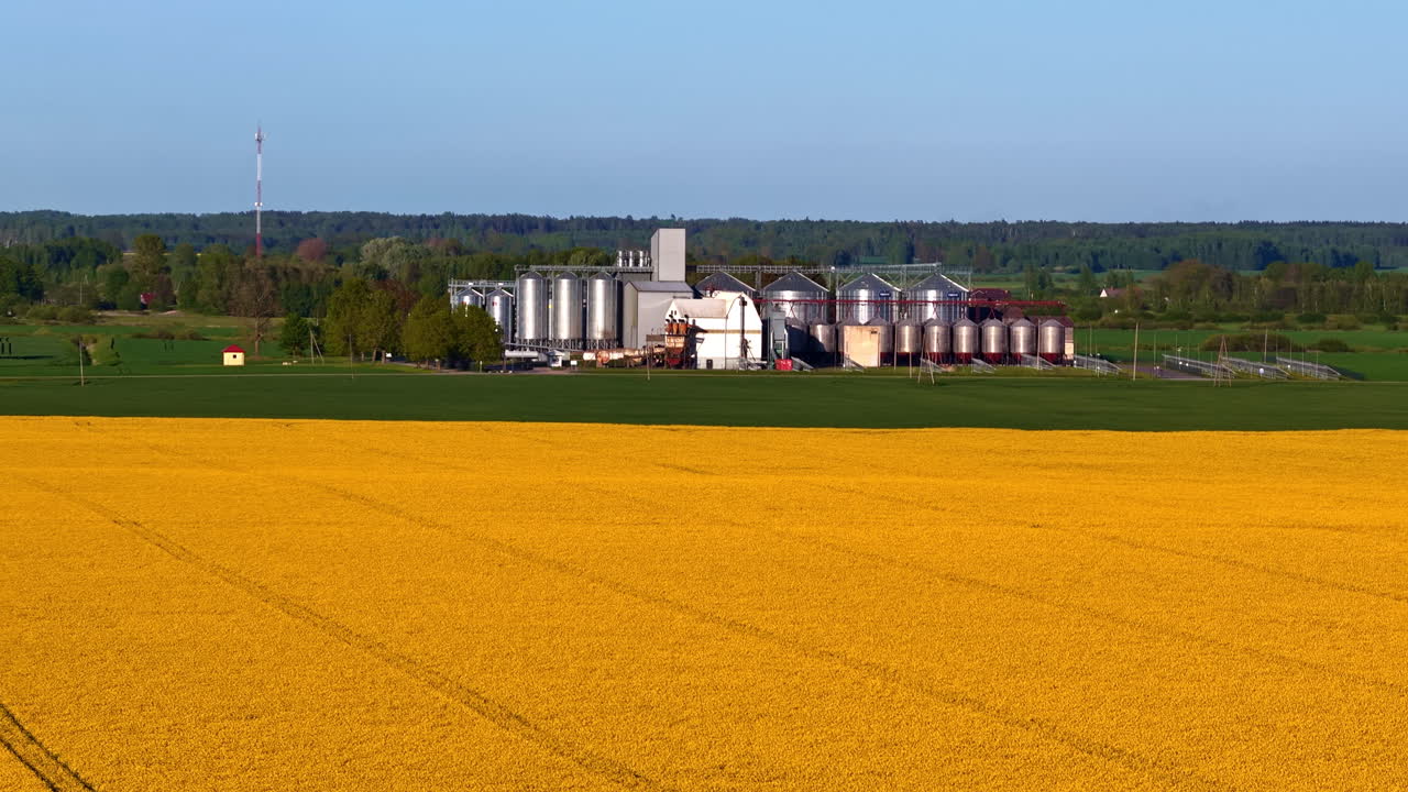 Tall cylindrical silos store grain or feed, preserving quality and preventing spoilage in farms and industry.