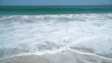 first person view of tropical beach with waves and turquoise water