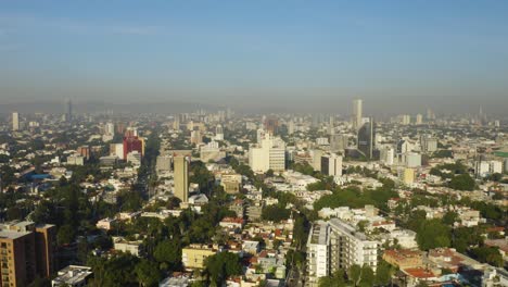 drone flies away from tall buildings, reveals historic catholic church