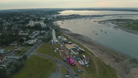 aerial 4k pan of amusement park beside the sea