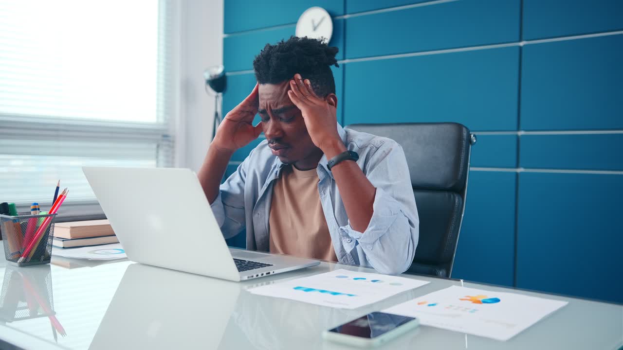 Disoriented african american man stressed by business problems in office