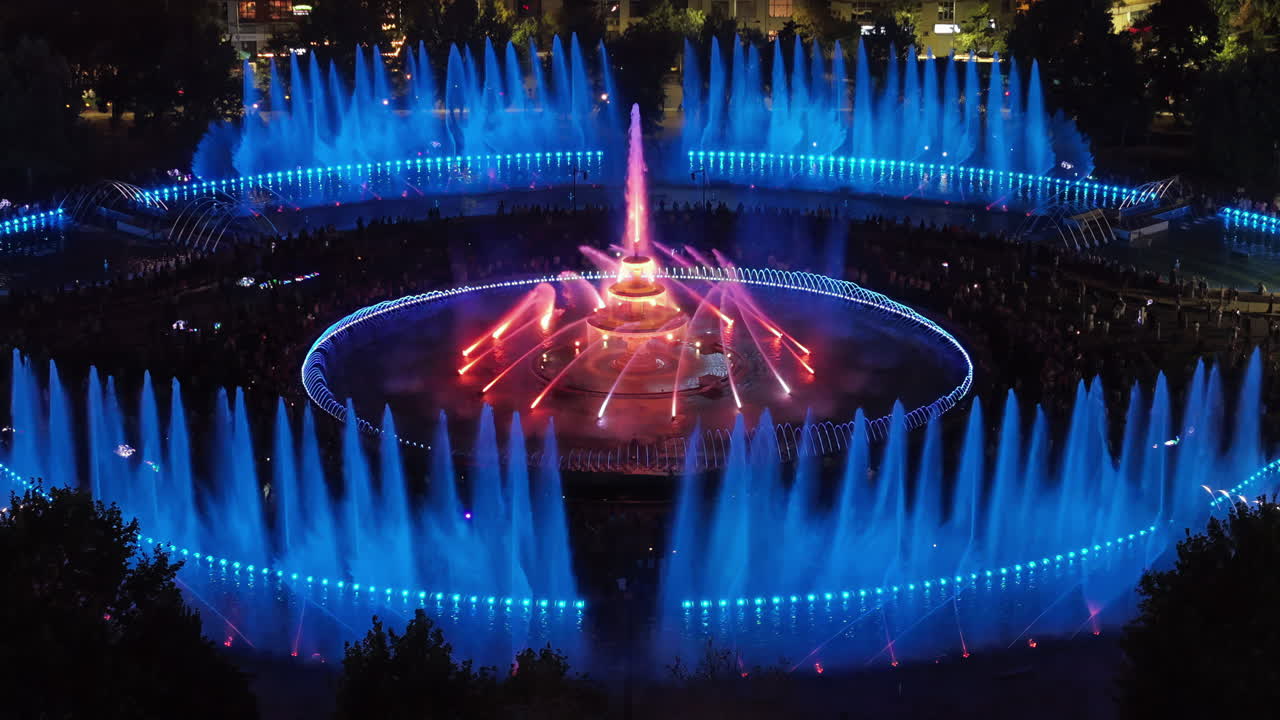 Aerial drone view of the illuminated Bucharest fountains in Romania, at night