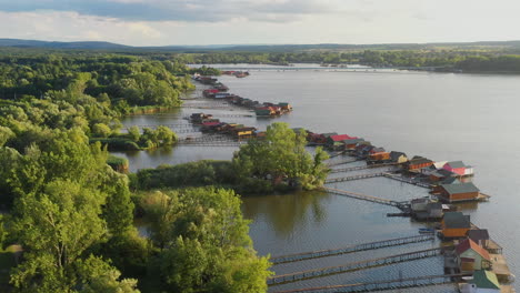 cinematic drone shot of stilt village over the bokodi-hutoto lake in hungary