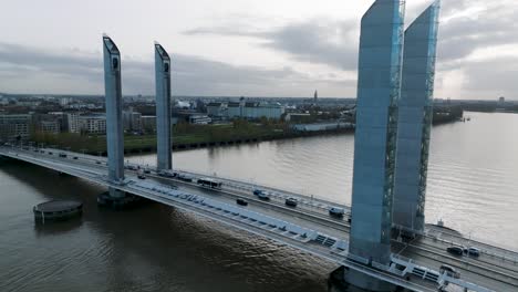 car traffic over jacques chaban delmas bridge on the garonne river in bordeaux france, aerial dolly out reveal shot