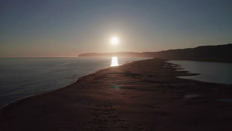 Sun-setting-over-Raudisandur-Beach-in-Westfjords-of-Iceland---Forward-Aerial