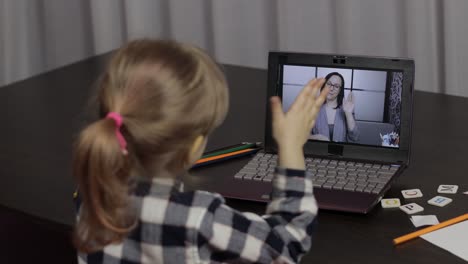 girl distance education lesson with woman teacher, using digital laptop at home