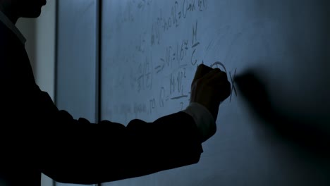 student working on math equations on a whiteboard