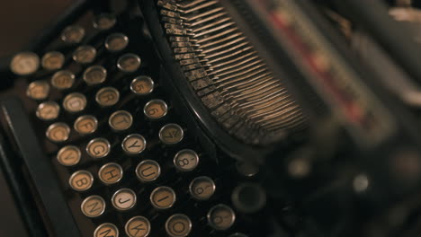 abstract closeup dolly shot of an isolated vintage typewriter - dolly right and tilt up