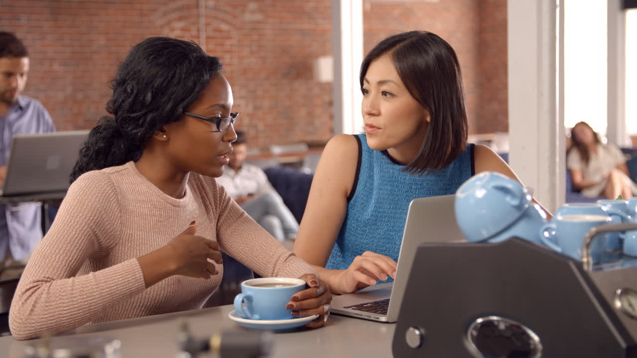 Businesswomen Have Informal Meeting In Office Coffee Bar