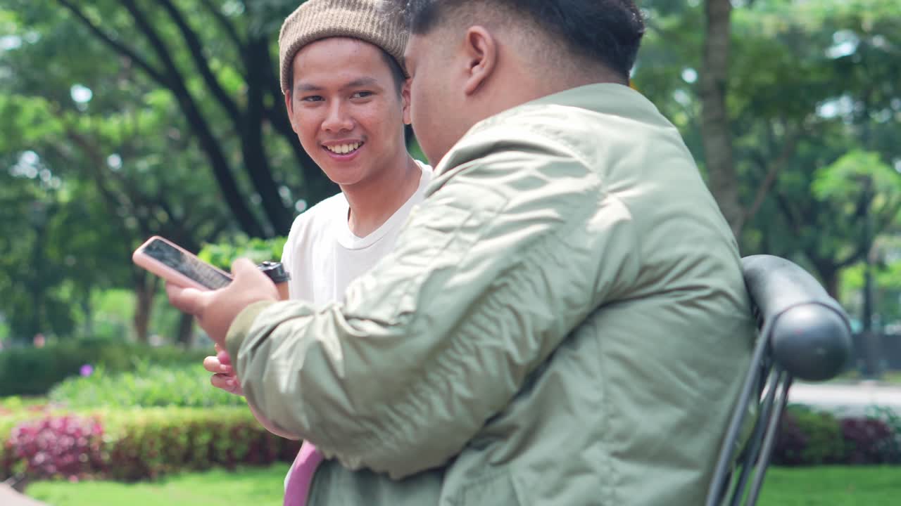 Two Asian College Students Enjoying Drinking Coffee At Park While Using Smartphone