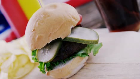 hamburger and cold drink on wooden board