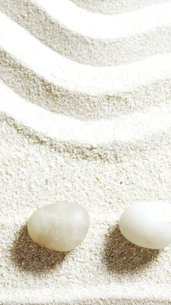 Various pebble stone arranged on sand
