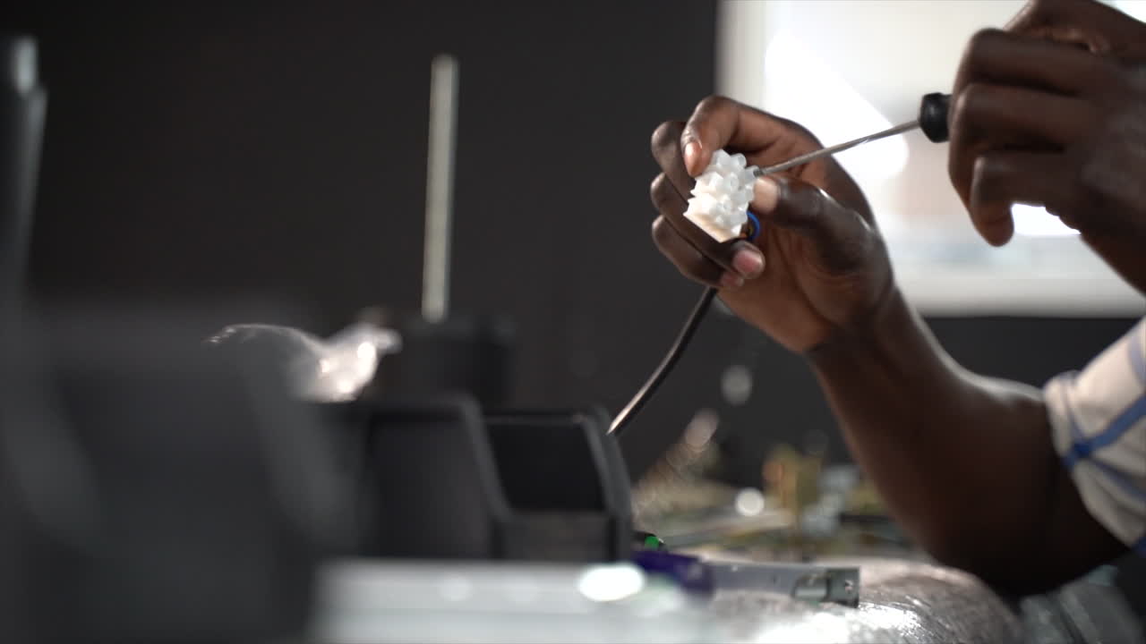 Person connecting wires through a cable connector