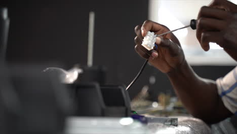 person connecting wires through a cable connector