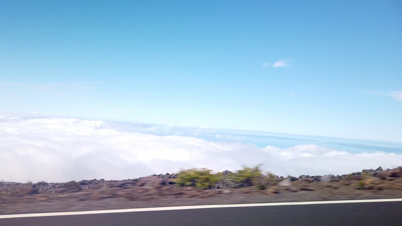 Gimbal POV shot from a moving vehicle driving on a road above the clouds near the summit of Haleakala in Maui, Hawai'i