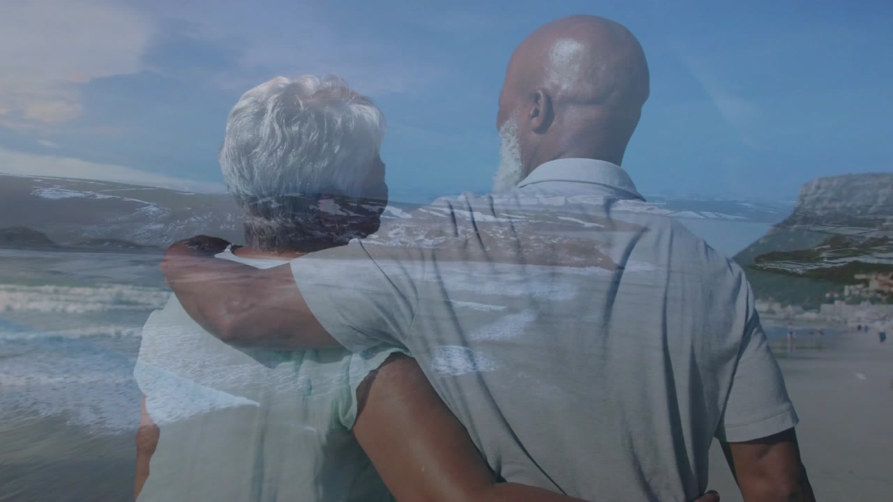 Man placing arm around woman's shoulders, couple walking shoreline with wave overlay for health