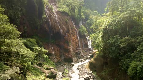 waterfall nestled in a landscape prone to landslides, 4k aerial drone footage
