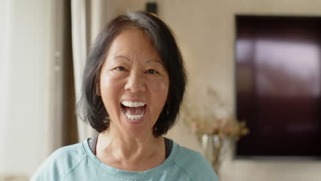 smiling senior asian woman relaxing at home, savoring peaceful moment