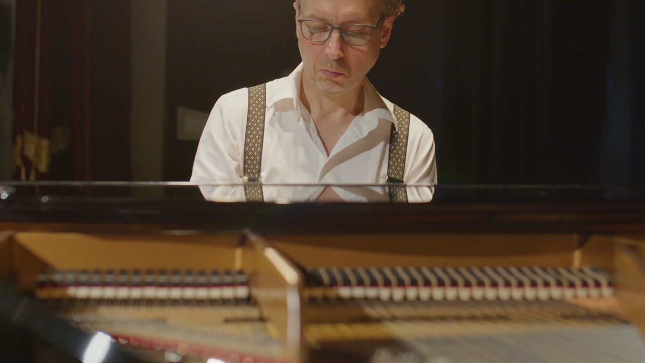 Virtuoso Pianist Playing Grand Piano on Stage